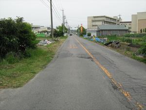 写真：施工前の写真　車の交通量が多く歩道がなく危険な道路でした